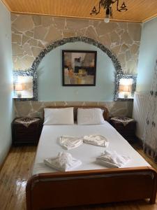 a bedroom with a bed with two towels on it at BACI HOUSE in Limenas