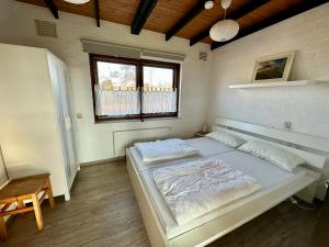 a bedroom with a large bed in a room at Boerenslag 45 in Sint Maartensvlotbrug +5 photos