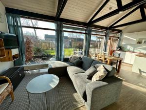 a living room with a couch and a table at Boerenslag 45 in Sint Maartensvlotbrug