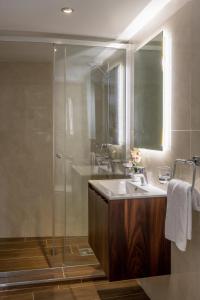 a bathroom with a sink and a shower at The Siggiewi Suites in Siġġiewi