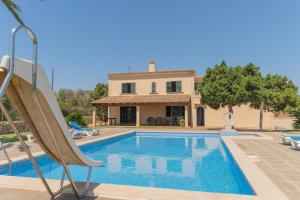 a villa with a swimming pool and a house at Finca Sivina Sanau in Cala Ferrera