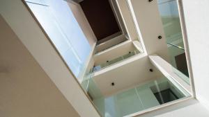 a room with glass shelves and a mirror at Welcomely - Affittacamere Seamphony Suites in Olbia +67 photos