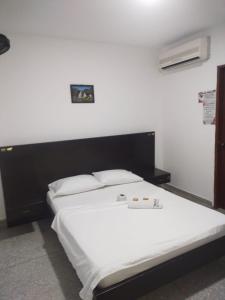 Postel nebo postele na pokoji v ubytování Hotel Los Arcángeles