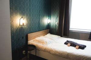 a bedroom with a bed with two bags on it at 50 m2 Apartment Next To Montmartre in Paris