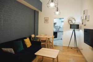 a living room with a couch and a table at 50 m2 Apartment Next To Montmartre in Paris