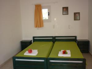 A bed or beds in a room at Manolis Farm Guest House