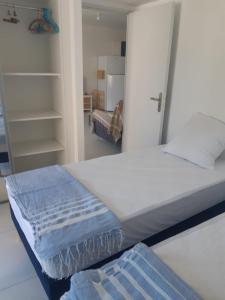a bed in a room with a mirror and a room with at Appartement neuf 4pers. 250 mètres de la plage in Argelès-sur-Mer