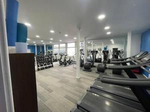 a gym with rows of treadmills and elliptical machines at One bedroom serviced apartment Smethwick flat 310 in Birmingham