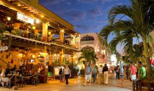a group of people walking on a street at night at Oceanblue by Andiani Travel in Playa del Carmen
