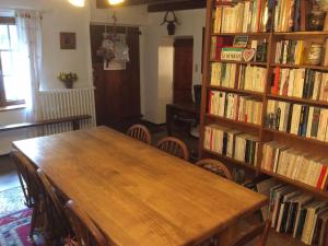 a room with a table and a book shelf filled with books at Chalet Valloire, 5 pièces, 8 personnes - FR-1-263-397 in Valloire