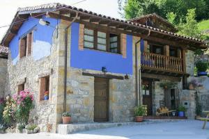 uma casa azul com uma varanda em cima em La xica ll em Beceña