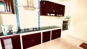a kitchen with brown cabinets and a counter top at 3 Bedroom Sea View Villa Poppy SDV343-By Samui Dream Villas in Koh Samui 