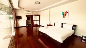 a bedroom with a large bed and wooden floors at 3 Bedroom Sea View Villa Poppy SDV343-By Samui Dream Villas in Koh Samui  +29 photos