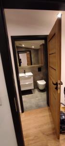 a bathroom with a tub and a toilet and a sink at Seepark 13a in Goch