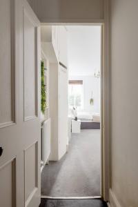 a hallway with a door leading to a living room at Spacious Apt In Central London in London