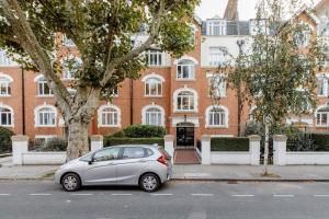 a small silver car parked in front of a building at Spacious Apt In Central London in London