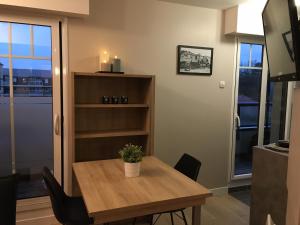 un tavolo da pranzo con una pianta in vaso sopra di Appartement Touquet 's Times a Le Touquet-Paris-Plage