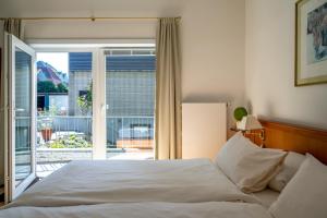 Postel nebo postele na pokoji v ubytování Hotel Gregory Wyk auf Föhr