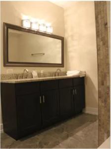 a bathroom with a sink and a mirror at Entire 3 bedroom Private Luxury Condo in Washington, D.C.