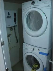 a washing machine and a washer in a bathroom at Entire 3 bedroom Private Luxury Condo in Washington, D.C.
