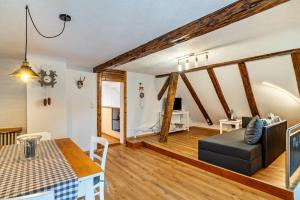 a living room with a table and a couch at Schwarzwaldtani - Städtle in Bühl