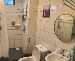a bathroom with a toilet and a sink and a mirror at Kensington Sunrise sg, Palas Horizon,kea farm in Brinchang