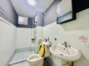 a bathroom with a toilet and a sink at 8 pax Homestay near Axiata Arena & Pavilion 2 in Kuala Lumpur