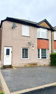 a brick house with white doors and windows at Clyde 52 in Glasgow