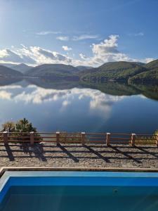 a swimming pool with a view of a lake at Pensiunea Belvedere Cincis in Cinciş