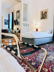 a bedroom with a bed and a rug at Pd Residence in Budapest