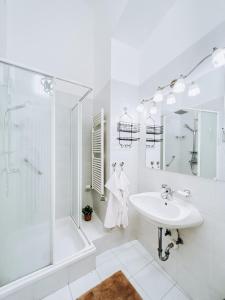 a white bathroom with a shower and a sink at Pd Residence in Budapest