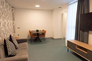 a living room with a couch and a table at RK Farallón Canteras in Las Palmas de Gran Canaria