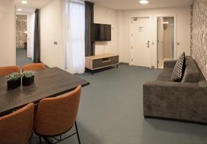 a living room with a table and a couch at RK Farallón Canteras in Las Palmas de Gran Canaria