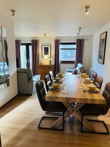 a dining room with a large wooden table and chairs at The Galleries No 2 in Spean Bridge