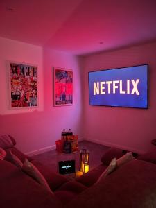 a living room with a netflix sign on a wall at Terfyn Hall holiday Apartment 2 in Prestatyn
