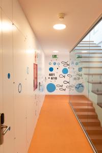 a hallway with stairs and a wall with blue circles at RK Farallón Canteras in Las Palmas de Gran Canaria