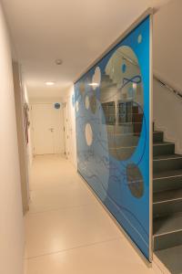 a hallway with a mural on the wall at RK Farallón Canteras in Las Palmas de Gran Canaria