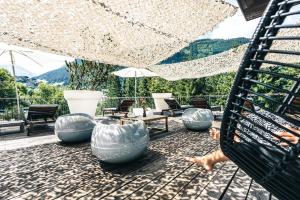 a person is jumping off of a hammock on a patio at Design Hotel Miramonte in Bad Gastein