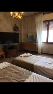 Кровать или кровати в номере Casa Padronale Arpiola 10 persone