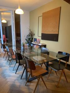 a dining room with a glass table and chairs at B&B DRUUM in Brussels