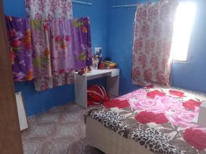 ein Schlafzimmer mit einem Bett und Vorhängen sowie einem Fenster in der Unterkunft Casa Mobiliada in Manaus