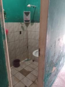 a bathroom with a sink and a toilet in it at Casa Mobiliada in Manaus