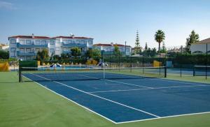 a tennis court with two tennis rackets on it at Oasis park 2 bedroom top floor Apartment AT72 in Portimão