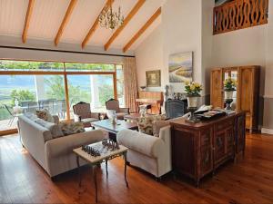 a living room with couches and a table at Valley View Eco Country Estate - Paradise in the Winelands in Villiersdorp