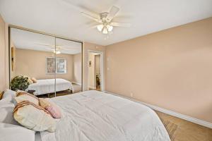 a bedroom with a large bed and a mirror at Newly Renovated One Bedroom Apartment in Funk Zone in Santa Barbara