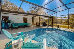 a swimming pool in a house with a glass extension at Linda’s Lizard Landing in Port Orange