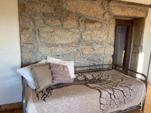 a stone wall with a bed in a room at The Loft With a View in Cabeceiras de Basto +71 photos