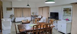 a living room with a dining table and a room with a bed at MeliGchu in Gualeguaychú