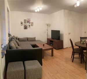 a living room with a couch and a table at Ferienwohnung VIER BUCHEN in Weißwasser