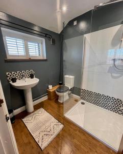 a bathroom with a shower and a sink at The Cart Lodge at Lee Wick Farm Cottages & Glamping in Saint Osyth +23 photos